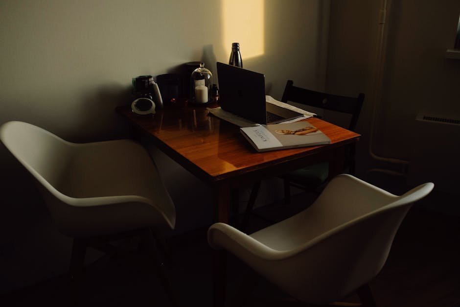 Two chairs facing each other in a quiet office with a cross subtly visible on the wall, soft natural light, no people, conveying a faith-integrated counseling setting