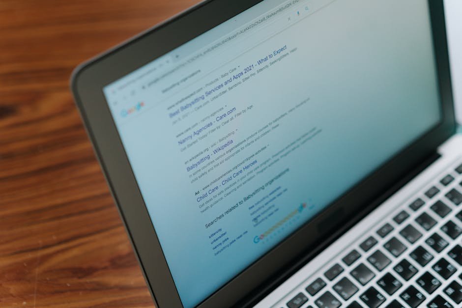 An open laptop showing a therapist directory search results page next to a notebook with handwritten questions