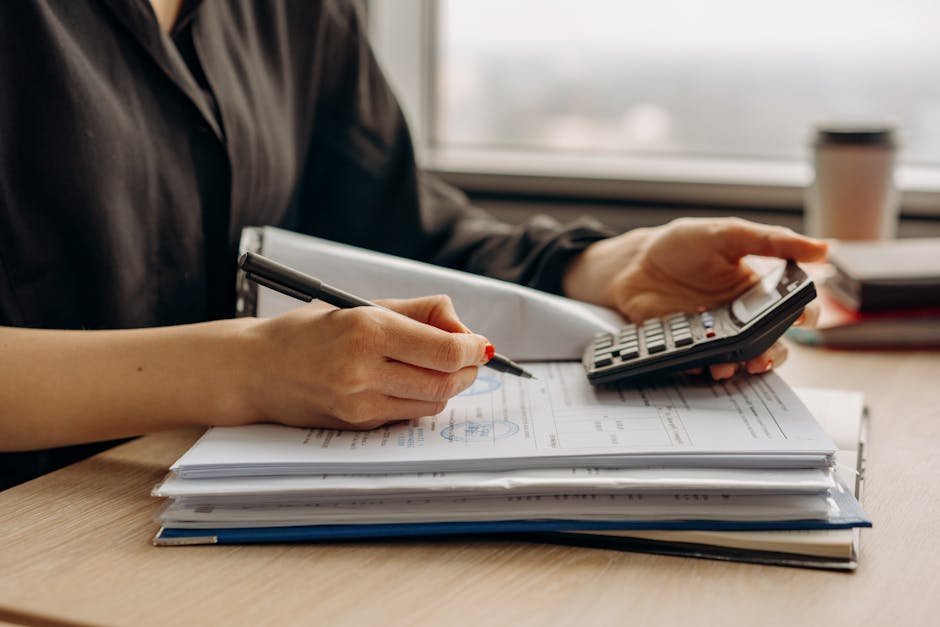 Insurance documents and a calculator on a desk