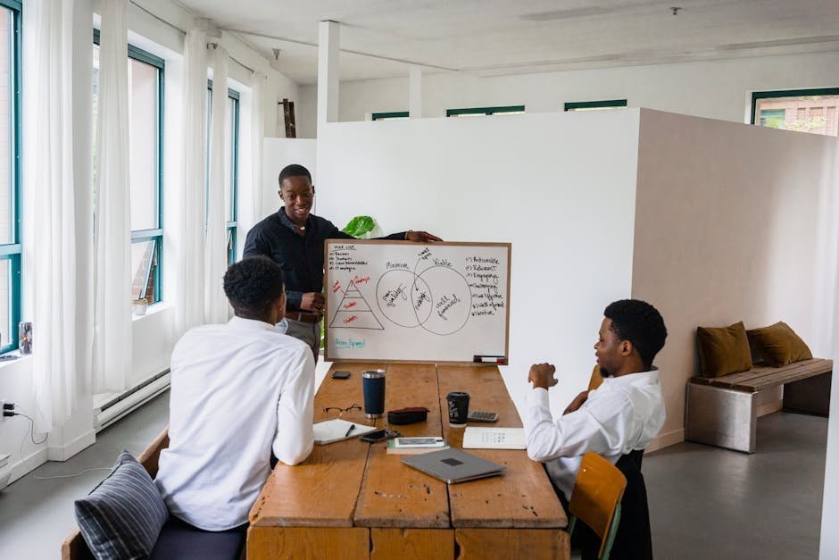 Treatment team meeting room with whiteboard showing integrated care plan, several clinicians around a table with patient charts, conveying multidisciplinary approach