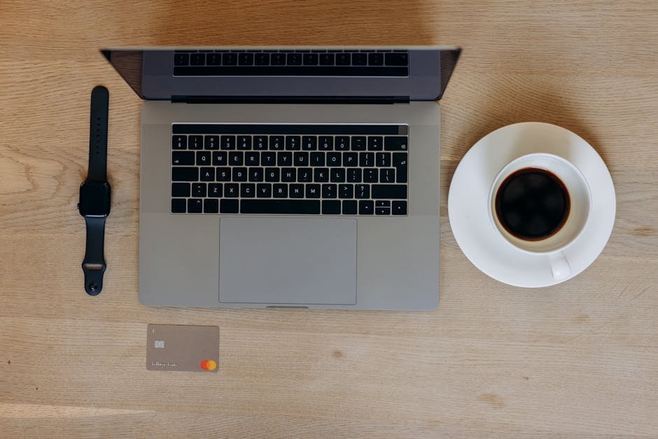 Smartwatch resting on an open journal beside a cup of coffee