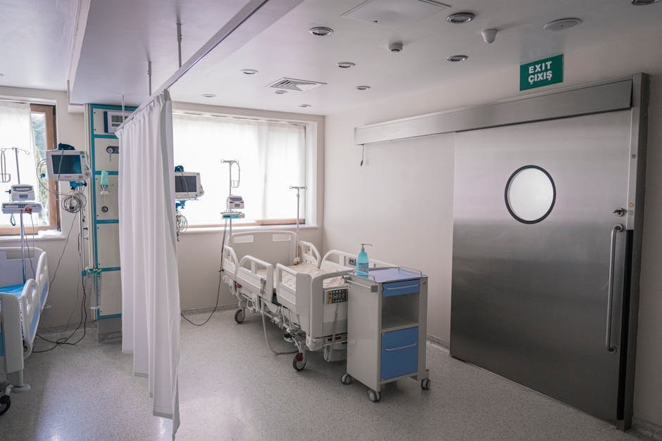 Inpatient psychiatric hospital room with single bed window and supportive nurse station nearby