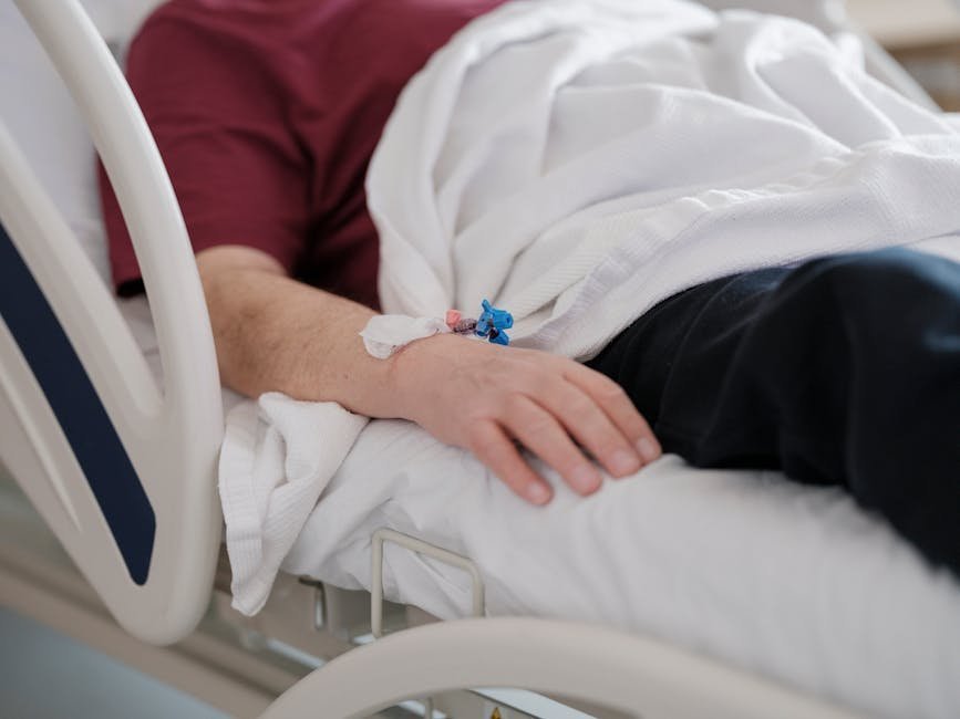 Patient resting in hospital bed during stimulant withdrawal recovery with daylight through window