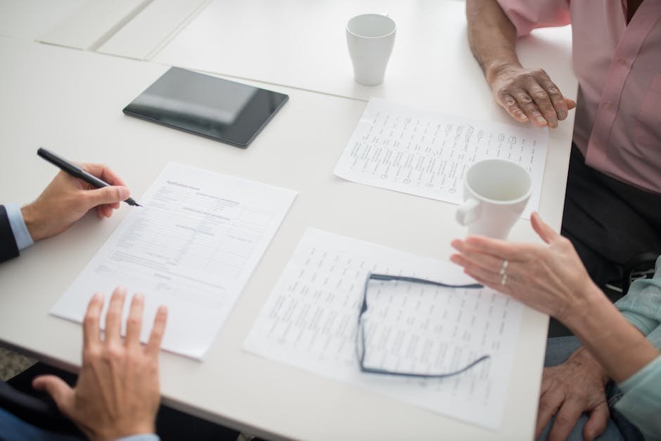 Patient meeting with insurance counselor reviewing rehab cost estimate documents